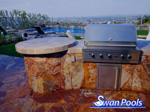 Small arc BBQ with tile top, stone sides, and a circular table top.  Click on image for a larger picture.