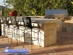 Custom shape, modern barbeque with tile top, tile sides, and serving shelf.  Click on image for a larger picture.