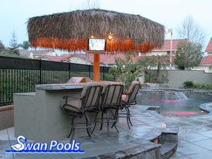 Custom arc barbeque with palapa, tile top, raised serving shelf, and stucco sides.  Click on image for a larger picture.