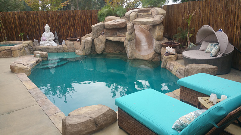 Swan Pools, an award winning swimming pool builder, created a custom sunny oasis in the rolling hills of Northern California.  The classic Californian relaxation swimming pool includes stone coping, stone deck, led lighting, mottled grey plaster, and a freestanding lattice patio cover.  The swimming pool in the surrounding environment invites relaxation on a long, sunny Sunday afternoon.