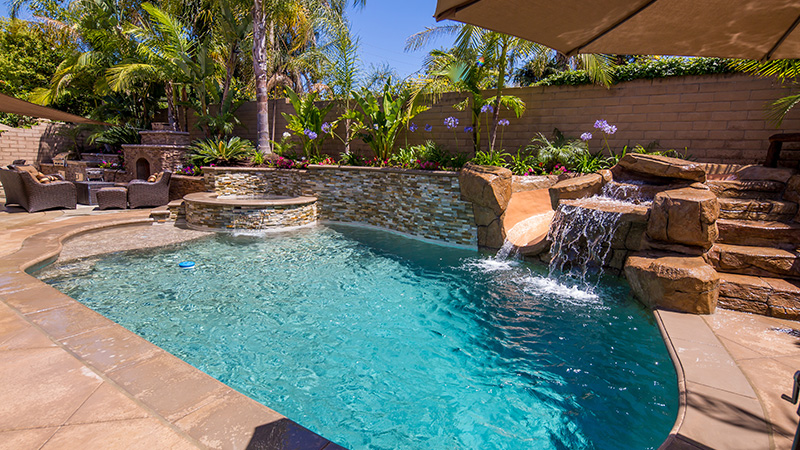 Custom swimming pool design with separate spa in California Wine Country.  Toast the evening lounging in your custom built spa.  Details in the construction project include raised spa, concrete coping, pebble interior plaster, artificial rocks, and waterway theuraputic jets. 