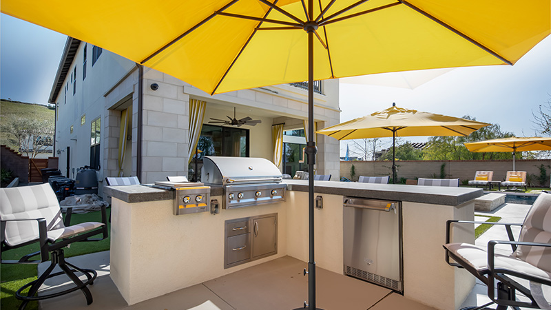 Swan Pools, an award winning swimming pool builder, created a custom sunny oasis in the rolling hills of Northern California.  The classic Californian relaxation swimming pool includes stone coping, stone deck, led lighting, mottled grey plaster, and a freestanding lattice patio cover.  The swimming pool in the surrounding environment invites relaxation on a long, sunny Sunday afternoon.