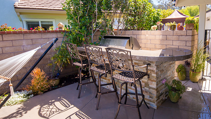 Modern swimming pool construction project in San Jose, California.  Sleek modern design in Silicon Valley with raised composite wood deck, concrete coping, stepping pads, smooth stucco veneered retaining wall and a Jandy/Zodiac sheer descent.  White interior quartz plaster.