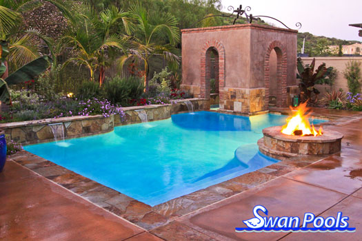 Swimming pool design meant for a quick dip, warmth around the fire, and intimacy in the spa.